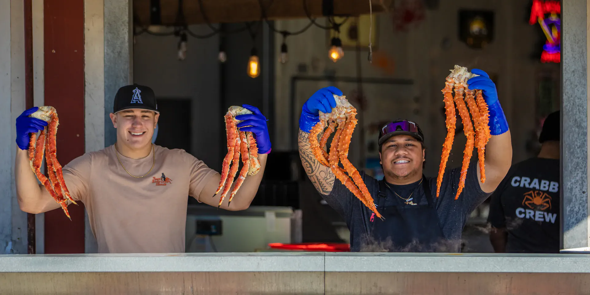 Busy outdoor seafood restaurant with customers waiting